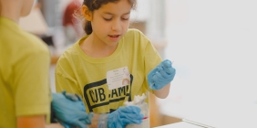girl doing science activity at summer camp