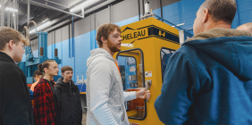 SSU student demonstrating industrial machine in SSU’s Advanced Manufacturing Center