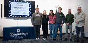 : Zachary Elliott, Chloe Sheridan, Breanna Carver, Jared Raynard, Dr. Jason Lovins and Dr. Terry Hapney Jr. celebrate the executive board inauguration with their chapter charter.