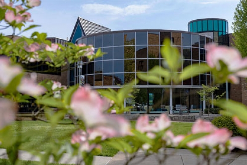 Image of SSU Morris University Center with flowers in the foreground